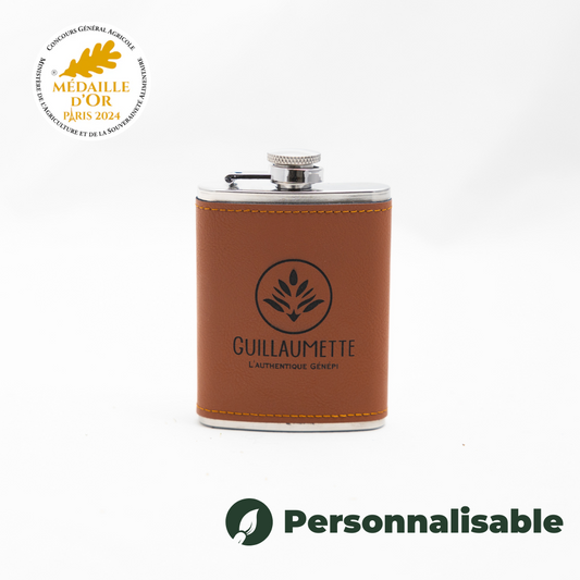 Flasque en cuir de 10 cl contenant du génépi authentique Guillaumette, personnalisable, médaillée d’or au Concours Général Agricole 2024.
